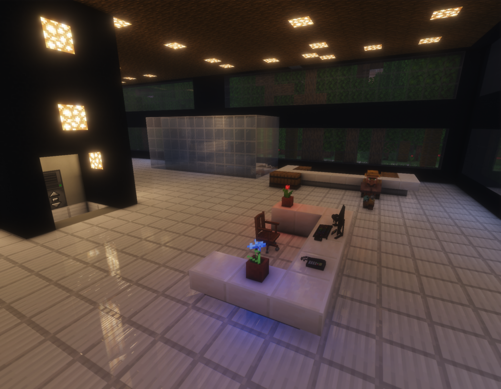 inside a fancy lobby where a desk has a computer, a flower, and a landline telephone
